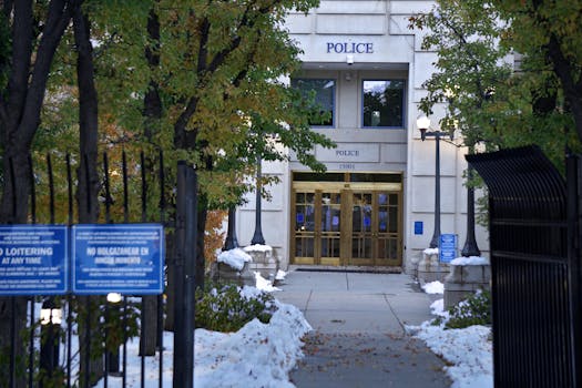 Police station entrance with snow on the ground and no loitering signs.