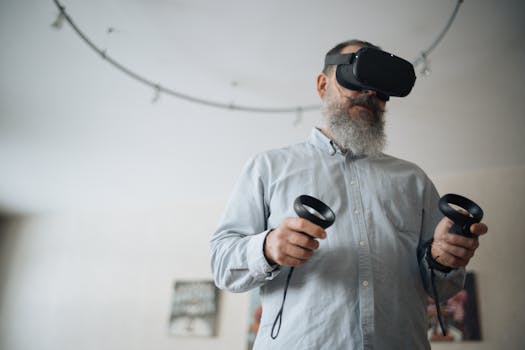 A senior man explores virtual reality using a headset and controllers indoors, showcasing technology interaction.