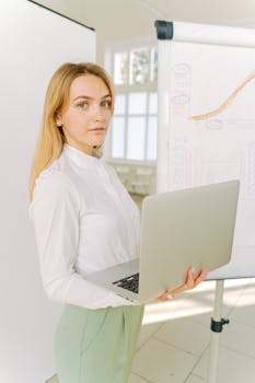 Confident businesswoman presenting data in a bright office setting.