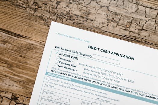 Top view of a credit card application form on rustic wooden background.